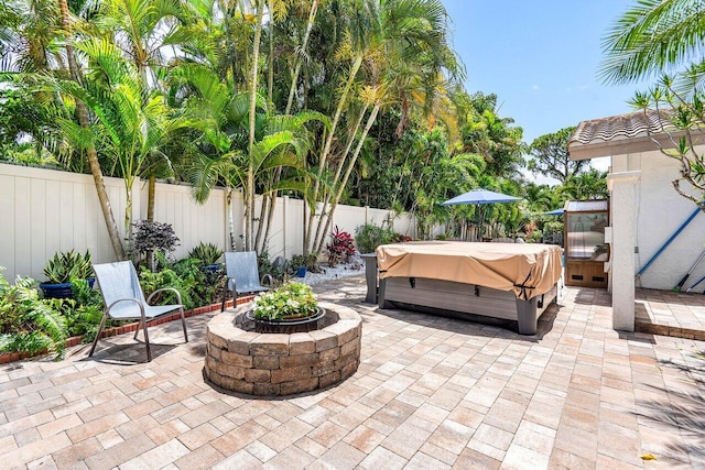 2626 NW 42nd St, Boca Raton, FL 33434 - fenced backyard with a hot tub, a patio area, and an outdoor fire pit