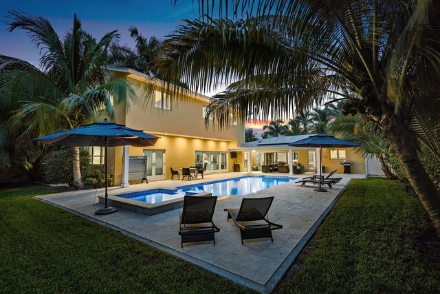 310 NW 18th St, Delray Beach, FL 33444 - view of swimming pool with french doors, a patio, a lawn, and a pool with connected hot tub