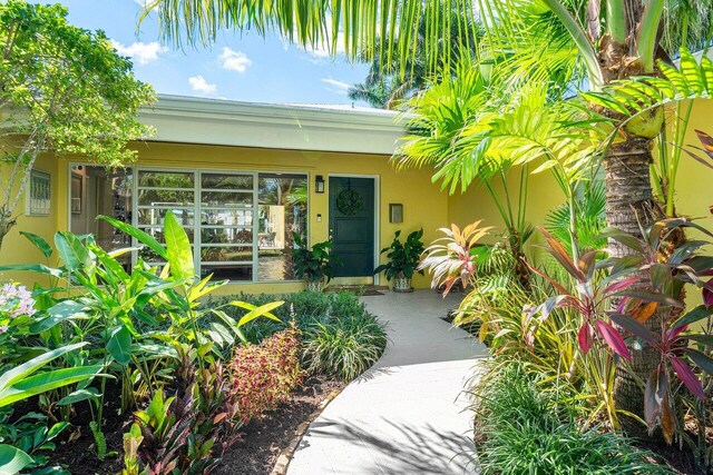 310 NW 18th St, Delray Beach, FL 33444 - view of exterior entry with stucco siding and covered porch