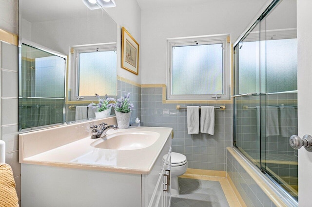 310 NW 18th St, Delray Beach, FL 33444 - full bath featuring healthy amount of natural light, vanity, tile patterned floors, toilet, and tile walls