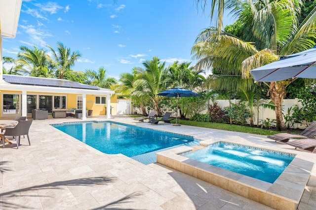 310 NW 18th St, Delray Beach, FL 33444 - view of pool featuring an in-ground hot tub, a patio area, an outdoor living space, and a fenced backyard
