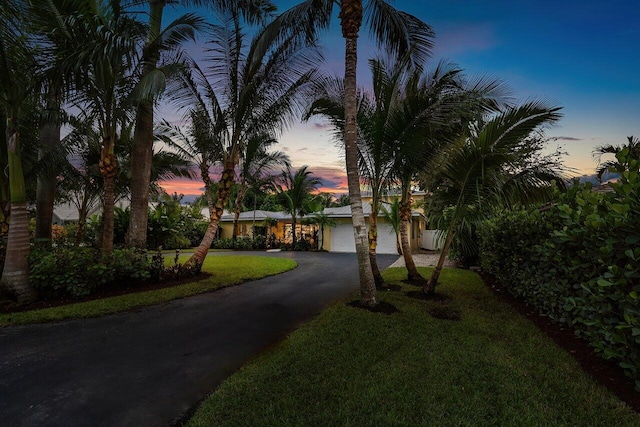 310 NW 18th St, Delray Beach, FL 33444 - view of front of home featuring driveway, a lawn, and a garage