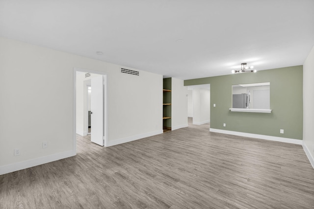 2517 S 17th St Unit 102, Fort Pierce, FL 34982 - unfurnished living room featuring wood finished floors and baseboards