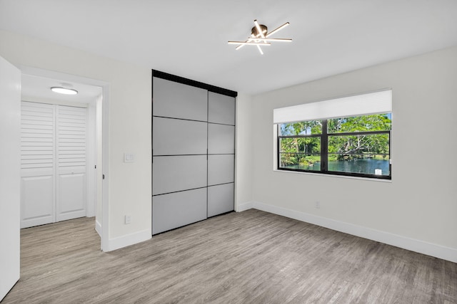 2517 S 17th St Unit 102, Fort Pierce, FL 34982 - unfurnished bedroom featuring light wood finished floors and baseboards