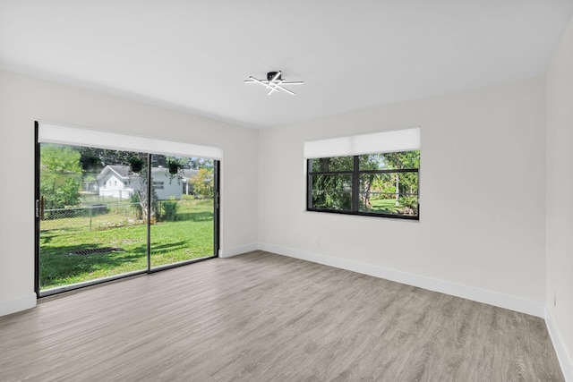 2517 S 17th St Unit 102, Fort Pierce, FL 34982 - spare room with healthy amount of natural light, baseboards, and wood finished floors