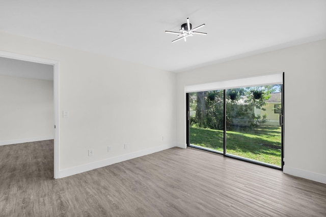 2517 S 17th St Unit 102, Fort Pierce, FL 34982 - empty room featuring wood finished floors, baseboards, and a ceiling fan