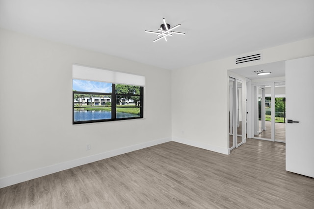 2517 S 17th St Unit 102, Fort Pierce, FL 34982 - empty room with wood finished floors and baseboards