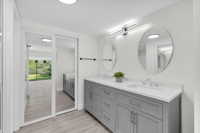 2517 S 17th St Unit 102, Fort Pierce, FL 34982 - full bath with double vanity, wood finished floors, and baseboards