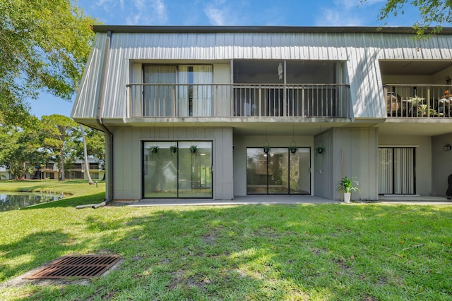 2517 S 17th St Unit 102, Fort Pierce, FL 34982 - back of house featuring a yard, a water view, a balcony, and a patio