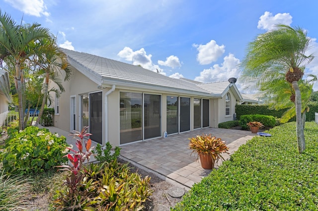 1415 Bear Island Dr, West Palm Beach, FL 33409 - rear view of property with a patio, a tile roof, and stucco siding