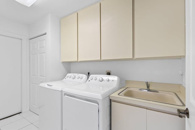 1415 Bear Island Dr, West Palm Beach, FL 33409 - laundry area featuring cabinet space, washing machine and clothes dryer, and light tile patterned floors