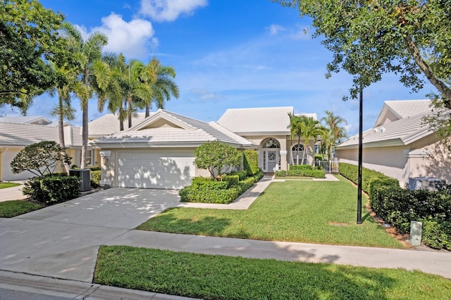 1415 Bear Island Dr, West Palm Beach, FL 33409 - view of front of house featuring a garage, a front lawn, central AC unit, concrete driveway, and a tile roof