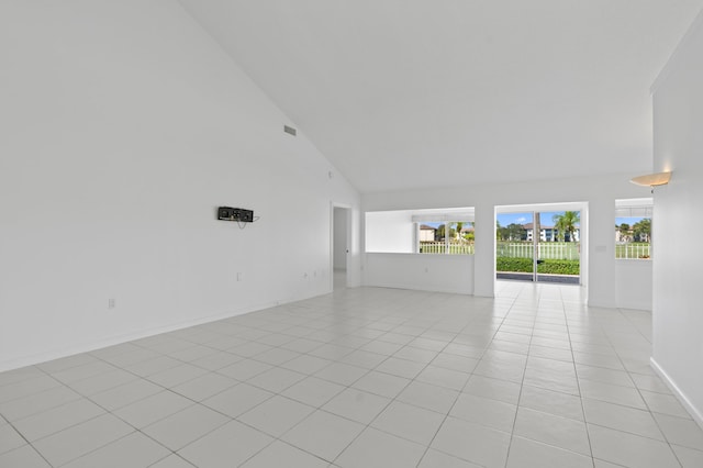 1415 Bear Island Dr, West Palm Beach, FL 33409 - unfurnished room with light tile patterned floors, high vaulted ceiling, and baseboards