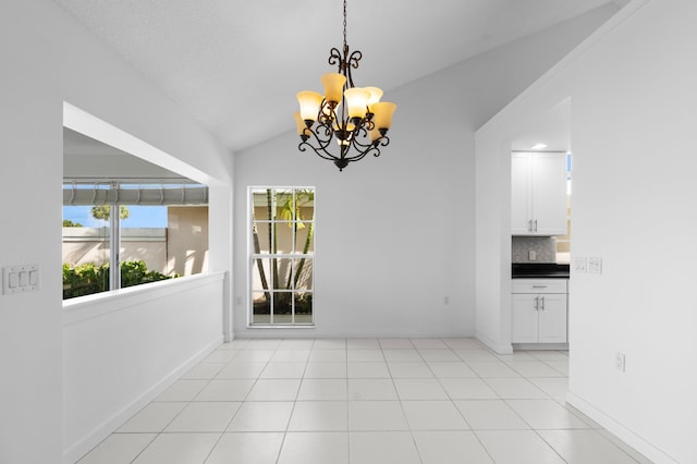1415 Bear Island Dr, West Palm Beach, FL 33409 - unfurnished dining area with a chandelier, vaulted ceiling, and baseboards