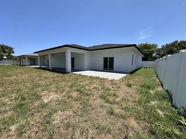 4641 Northview Dr, Jupiter, FL 33458 - back of property with a fenced backyard, a patio area, and stucco siding