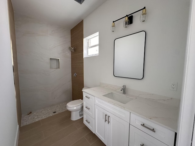 4641 Northview Dr, Jupiter, FL 33458 - bathroom with tiled shower, vanity, and wood finished floors