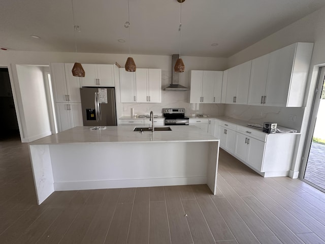 4641 Northview Dr, Jupiter, FL 33458 - kitchen with appliances with stainless steel finishes, wall chimney exhaust hood, a kitchen island with sink, light wood-style floors, and white cabinets