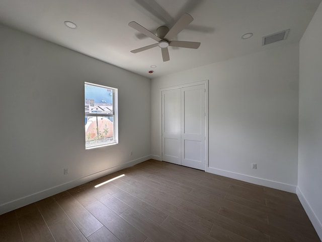 4641 Northview Dr, Jupiter, FL 33458 - unfurnished bedroom featuring dark wood finished floors, a closet, ceiling fan, and recessed lighting