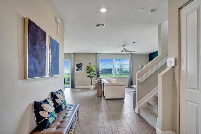 12623 NW Copper Creek Dr, Port Saint Lucie, FL 34987 - living room with stairs, wood finished floors, baseboards, ceiling fan, and recessed lighting