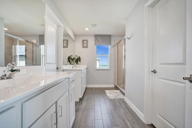 12623 NW Copper Creek Dr, Port Saint Lucie, FL 34987 - bathroom featuring vanity, a stall shower, baseboards, wood finished floors, and recessed lighting