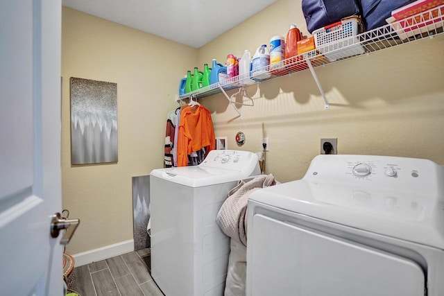 12623 NW Copper Creek Dr, Port Saint Lucie, FL 34987 - washroom with separate washer and dryer, wood tiled floors, and baseboards