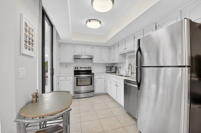 6815 Willow Wood Dr Unit 4022, Boca Raton, FL 33434 - kitchen with stainless steel appliances, under cabinet range hood, light tile patterned flooring, a sink, and decorative backsplash