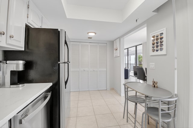 6815 Willow Wood Dr Unit 4022, Boca Raton, FL 33434 - kitchen with white cabinetry, appliances with stainless steel finishes, light countertops, light tile patterned floors, and baseboards