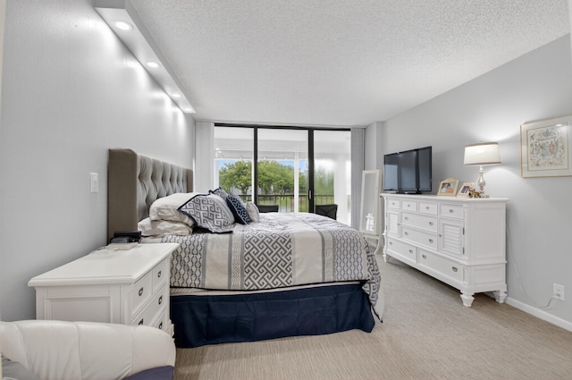 6815 Willow Wood Dr Unit 4022, Boca Raton, FL 33434 - bedroom featuring carpet, a textured ceiling, baseboards, expansive windows, and recessed lighting