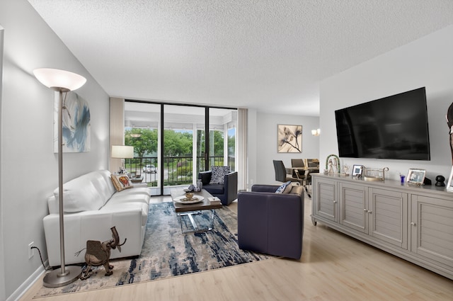 6815 Willow Wood Dr Unit 4022, Boca Raton, FL 33434 - living room featuring wood finished floors, a wall of windows, and a textured ceiling