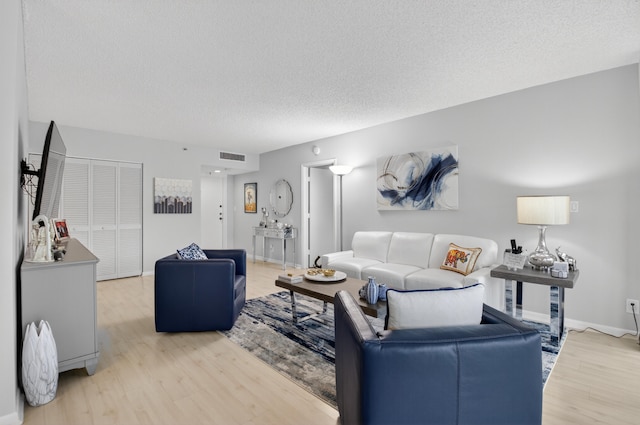 6815 Willow Wood Dr Unit 4022, Boca Raton, FL 33434 - living area with light wood-style floors, a textured ceiling, and baseboards
