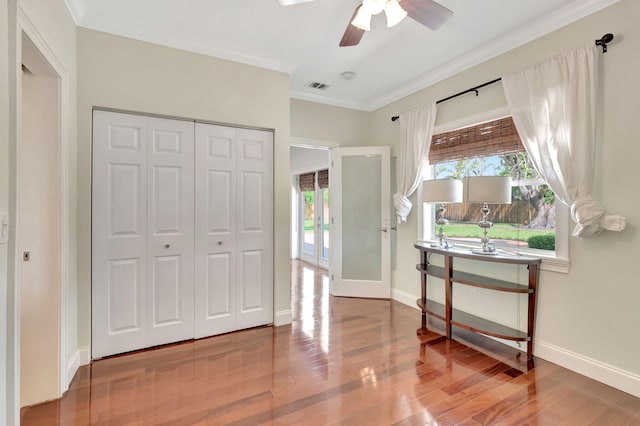3913 Sherwood Blvd, Delray Beach, FL 33445 - entryway featuring ceiling fan, wood finished floors, baseboards, and crown molding