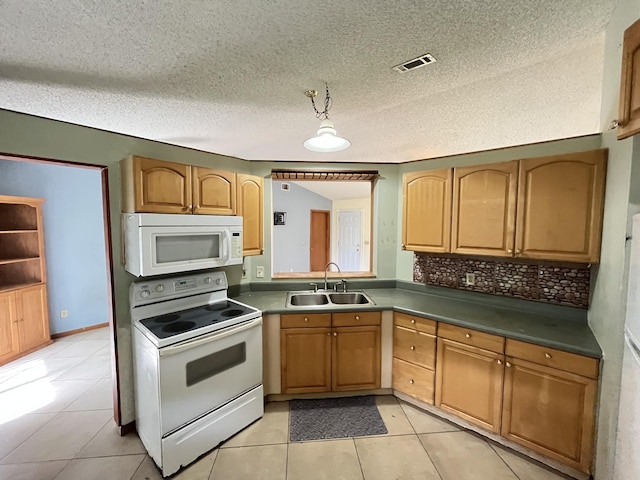 2955 SW Varsity Ln, Port Saint Lucie, FL 34953 - kitchen featuring white appliances, a sink, light tile patterned flooring, a textured ceiling, and decorative backsplash