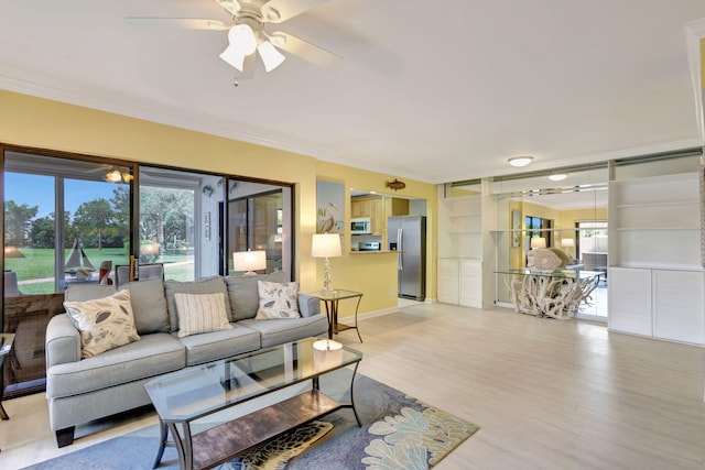 3209 S Lakeview Cir Unit 8-101, Hutchinson Island, FL 34949 - living room featuring ornamental molding, ceiling fan, and light wood-type flooring