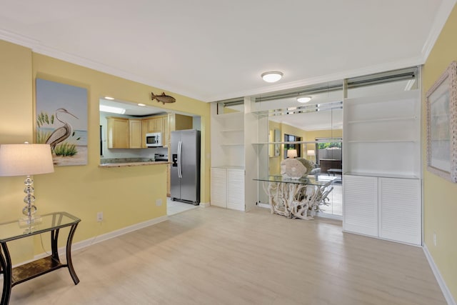 3209 S Lakeview Cir Unit 8-101, Hutchinson Island, FL 34949 - kitchen featuring stainless steel refrigerator with ice dispenser, white microwave, light brown cabinets, light wood finished floors, and ornamental molding