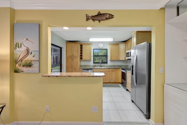 3209 S Lakeview Cir Unit 8-101, Hutchinson Island, FL 34949 - kitchen with appliances with stainless steel finishes, light brown cabinets, a peninsula, light tile patterned floors, and light stone countertops