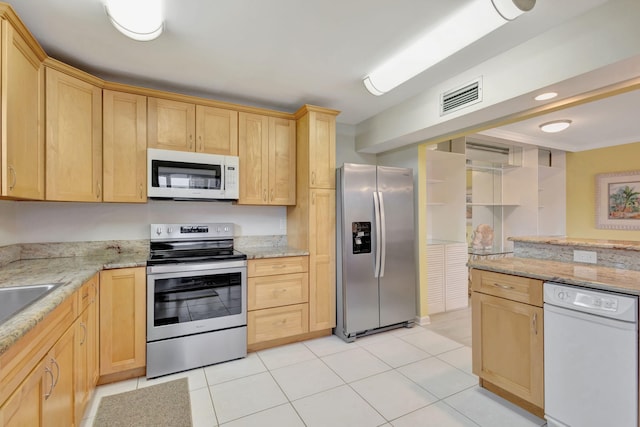3209 S Lakeview Cir Unit 8-101, Hutchinson Island, FL 34949 - kitchen with stainless steel appliances, light brown cabinetry, light stone countertops, and light tile patterned floors
