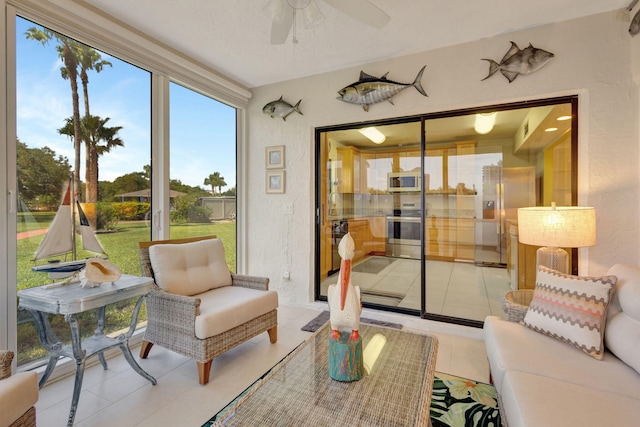 3209 S Lakeview Cir Unit 8-101, Hutchinson Island, FL 34949 - sunroom with ceiling fan, an outdoor living space, and tile patterned floors