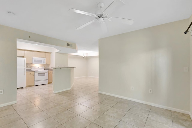 3693 NW Adriatic Ln, Jensen Beach, FL 34957 - spare room with light tile patterned floors, a ceiling fan, and baseboards