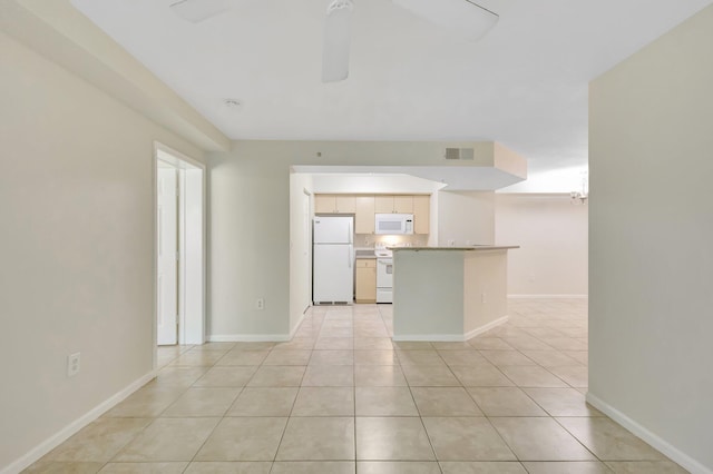 3693 NW Adriatic Ln, Jensen Beach, FL 34957 - kitchen featuring white appliances, light tile patterned floors, baseboards, light countertops, and open floor plan