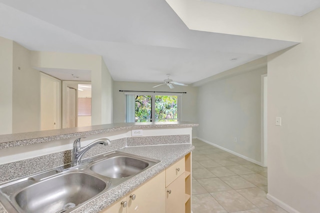 3693 NW Adriatic Ln, Jensen Beach, FL 34957 - kitchen with a sink, a ceiling fan, baseboards, light countertops, and light tile patterned floors