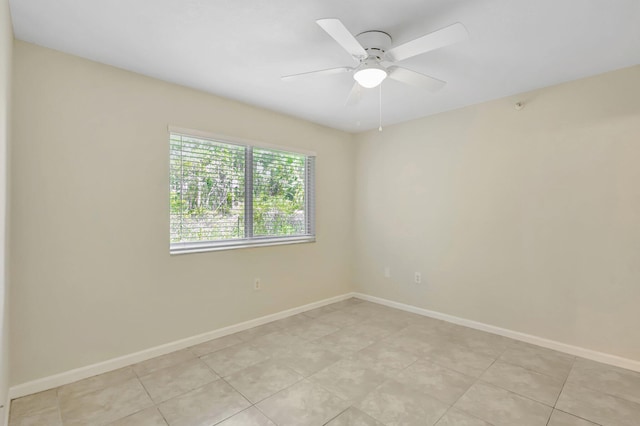 3693 NW Adriatic Ln, Jensen Beach, FL 34957 - empty room with baseboards, a ceiling fan, and light tile patterned floors