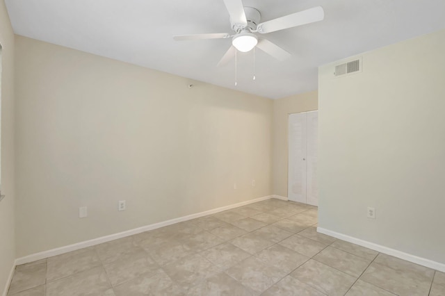 3693 NW Adriatic Ln, Jensen Beach, FL 34957 - empty room with ceiling fan, baseboards, and light tile patterned floors