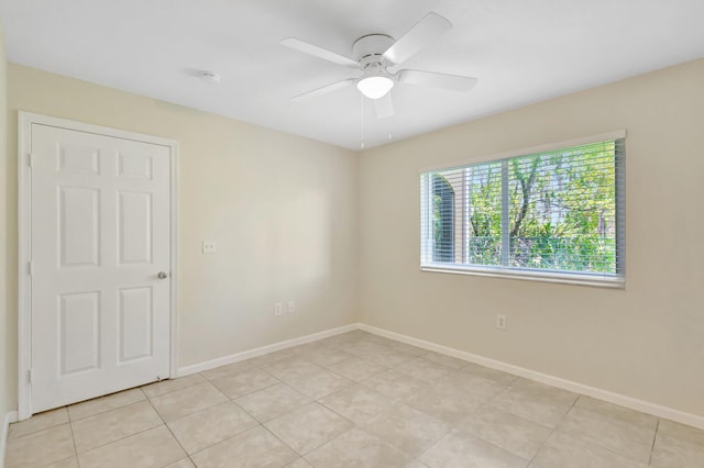 3693 NW Adriatic Ln, Jensen Beach, FL 34957 - unfurnished room featuring a ceiling fan, baseboards, light tile patterned flooring, and a smoke detector