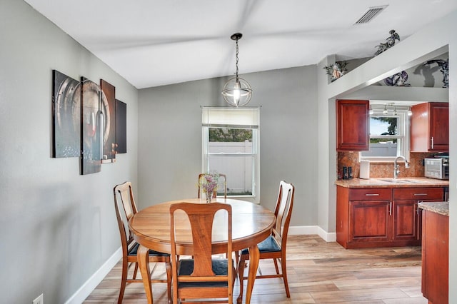 4641 Wadita Ka Way, West Palm Beach, FL 33417 - dining room featuring light wood finished floors, baseboards, and lofted ceiling