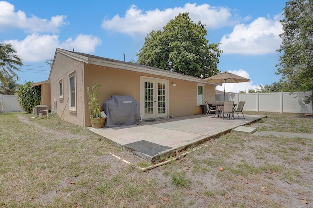 4641 Wadita Ka Way, West Palm Beach, FL 33417 - back of house with french doors, stucco siding, and a patio