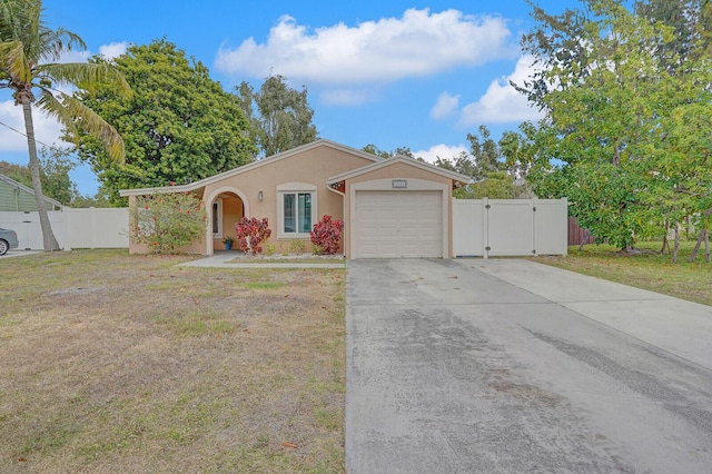 4641 Wadita Ka Way, West Palm Beach, FL 33417 - ranch-style house with a garage, stucco siding, a gate, and concrete driveway