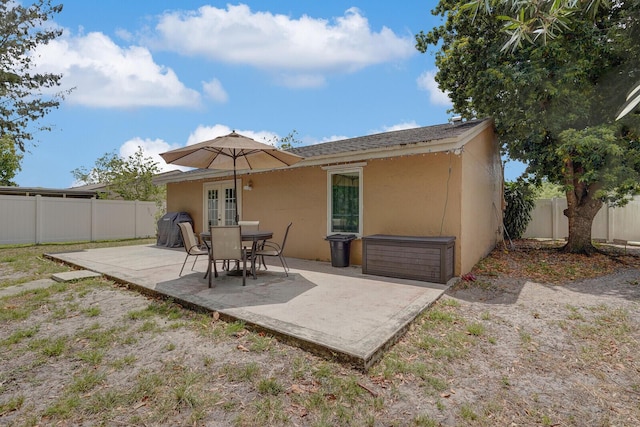 4641 Wadita Ka Way, West Palm Beach, FL 33417 - back of property featuring french doors, a patio area, a fenced backyard, and stucco siding