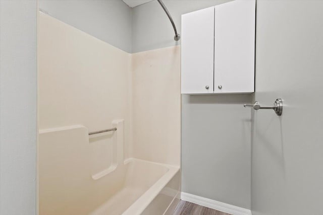 208 Olson Ave, Fort Pierce, FL 34946 - bathroom featuring baseboards, shower / bathtub combination, and wood finished floors