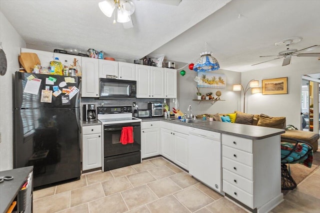 208 Olson Ave, Fort Pierce, FL 34946 - kitchen featuring black appliances, a ceiling fan, a sink, a peninsula, and white cabinets