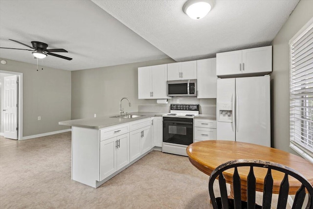 208 Olson Ave, Fort Pierce, FL 34946 - kitchen featuring white fridge with ice dispenser, electric range, a sink, stainless steel microwave, and a peninsula